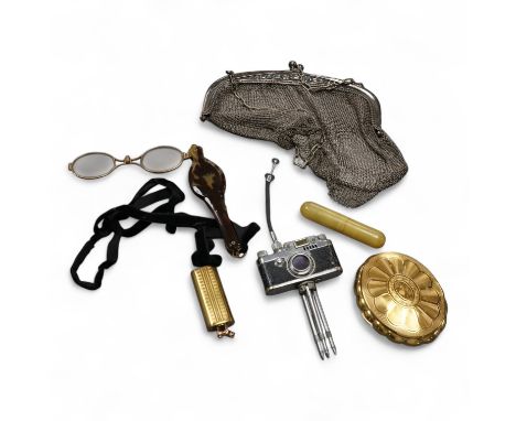 A miniature camera on stand,  a lorgnette,  mesh evening purse, compact, scent bottle and manicure set (6), purse 20cm high. 