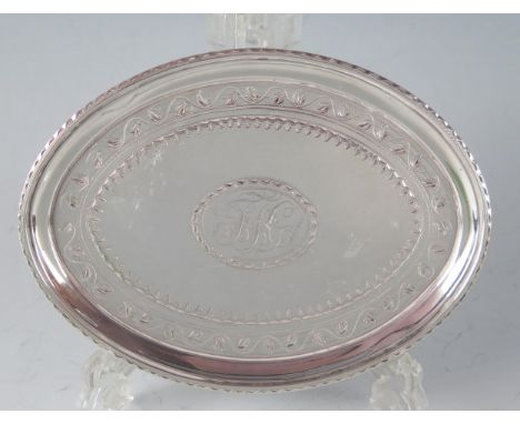 A George III silver teapot stand, maker Charles Aldridge, London, 1792, monogrammed, of oval form with chased banded decorati