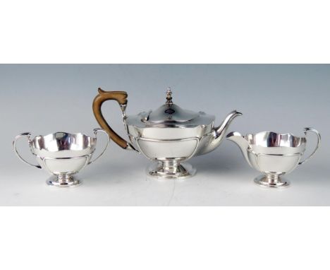 A George V silver three-piece tea service, maker Mappin &amp; Webb, Birmingham, 1912, of circular form with piped decoration,