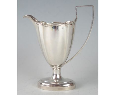 A George V silver cream jug, maker Mappin &amp; Webb, Sheffield, 1911, of helmet-shaped outline with reeded rim and handle, r