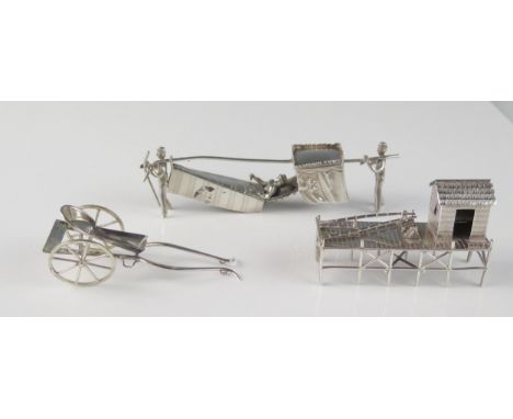 A Chinese silver model of a harbourside crane and cabin, , a two wheeled cart and and an eastern sedan style chair, total wei