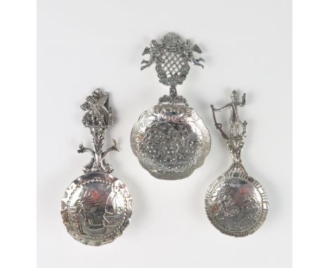 Three continental silver caddy and sifting spoons, all  bear import marks, with repousse decorated circular bowls and decorat