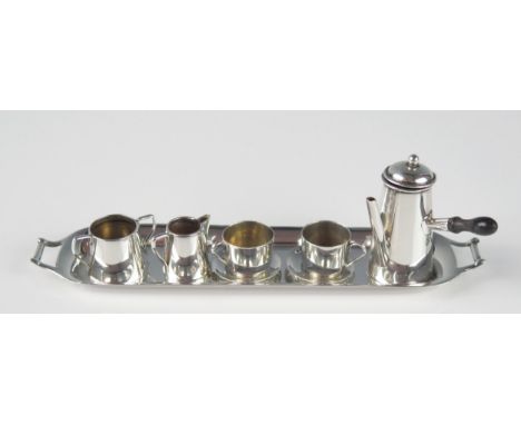 A matched miniature silver chocolate service, various makers and dates, includes, chocolate pot, cream jug, milk jug, two cup