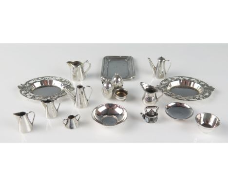 A collection of miniature silver items, including wash basin and jug, cream jugs, serving trays, bowls, cruet set etc, total 