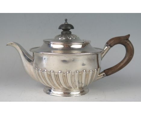 A Victorian silver circular bachelors teapot, maker Harrison Brothers &amp; Howson, Sheffield, 1890, with shallow domed hinge