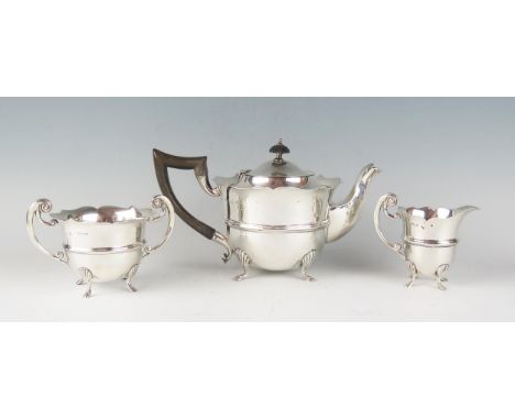 An Edward VII silver three-piece tea service, maker William Adams, Birmingham, 1902, of circular form with wavy-edge border, 