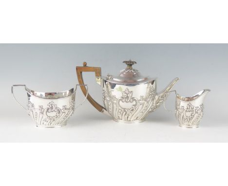 A Victorian silver three-piece tea service, maker Charles Stuart Harris, London, 1899/1900, of oval outline with embossed scr