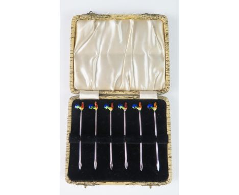 A set of six sterling silver and enamel cocktail sticks, the terminals in the form of cockerels, contained in a fitted case. 