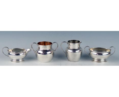 A George V silver cream jug and matching sugar basin, maker Docker &amp; Burn Ltd, Birmingham, 1925, of oval form with moulde