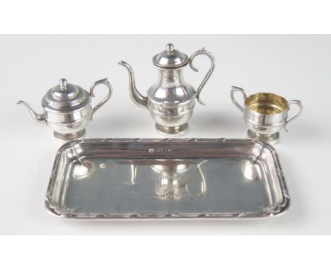 A miniature silver part tea and coffee service, includes teapot, coffee pot, sugar basin and a non matching serving tray, tot