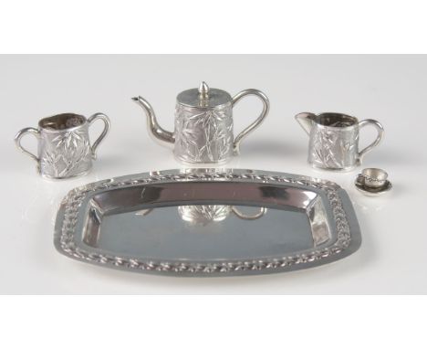 A Chinese silver three-piece miniature tea service, includes teapot, cream jug, sugar basin, non-matching cup and saucer and 