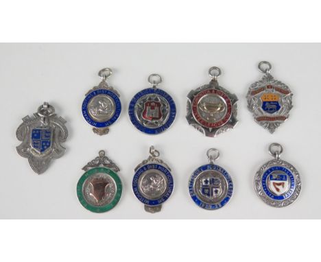 A collection of nine silver and enamel medallions/fobs, various makers and dates mostly related to football, gross weight 96g