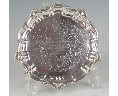 A Victorian silver circular waiter, maker Henry Wilkinson &amp; Co, Sheffield, 1852, inscribed, with shell and scroll border,