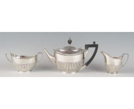 A matched George V silver three-piece bachelors tea service, various makers and dates, of oval outline with half reeded decor