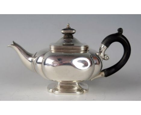 An Edward VII silver bachelors teapot, maker James Parkes, London, 1901, of squat square outline, raised on a rectangular foo