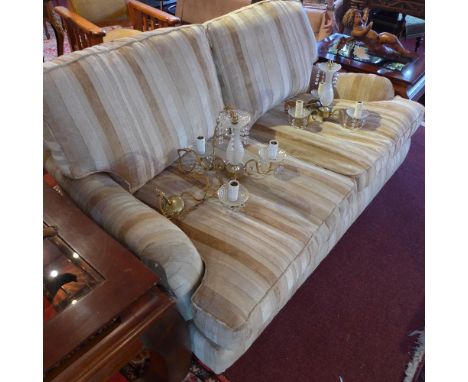 A Laura Ashley two seater sofa with striped upholstery, raised on turned legs and castors.  