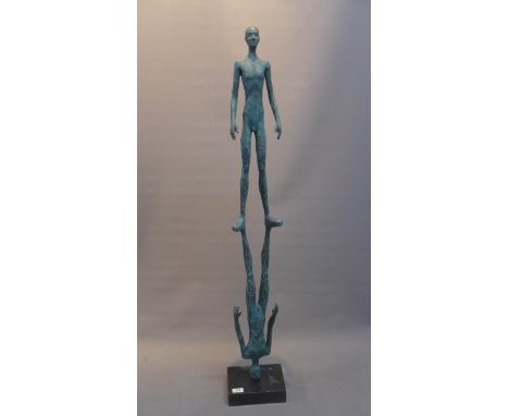 A contemporary bronze sculpture depicting two figures in a balancing act, on a marble base. Approx 180cm in height 