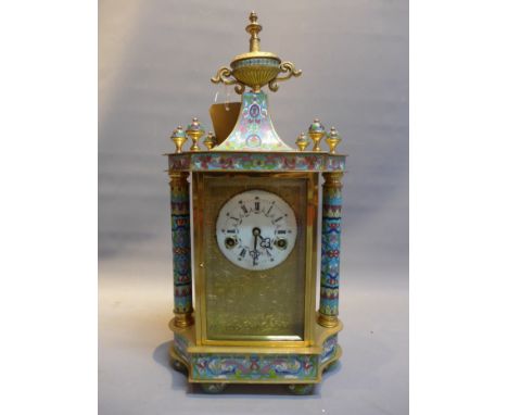 A 20th Century Chinese brass and cloisonne mantel clock with porcelain dial and side panels, having urn finial and raised on 