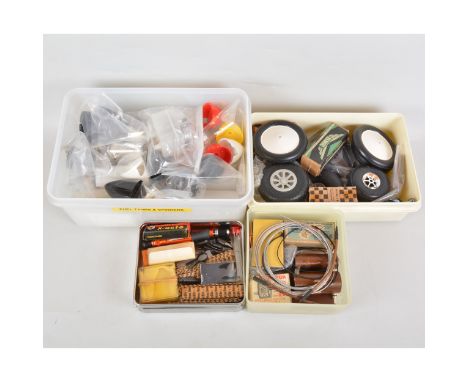 4 Boxes containing Fuel Tanks, Spinners, Wheels, Coils, engine timers and Model Knifes blade etc.