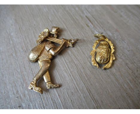 9ct Gold chimney sweep pendant together with a yellow metal pendant in the form of a scarab 
