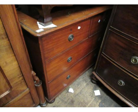 19th Century mahogany chest of two short over two long drawers with brass ring handles raised on low bun supports 