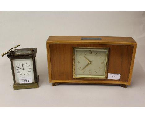 20th Century brass cased carriage clock with enamel dial together with a rectangular walnut cased mantel clock by Elliot, wit