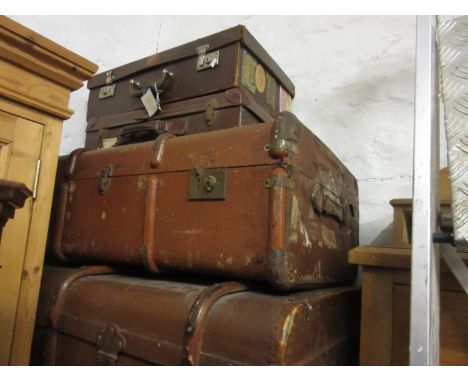 Group of five vintage travelling trunks, some with contemporary luggage labels, together with a leather suitcase similar 
