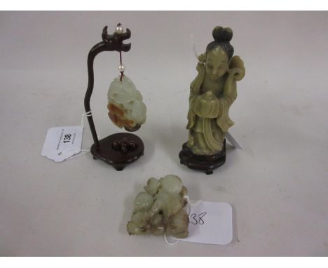 20th Century Chinese carved jade pendant on a stand, together with two other small similar carvingsCondition as shown in phot