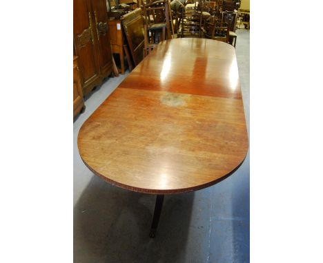 Mahogany three pillar dining table in George III style circa 1880, with a reeded frieze raised on turned carved column and tr