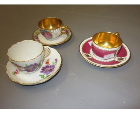 Late Meissen floral decorated cup and saucer and two other cups and saucers with gilt bowls 