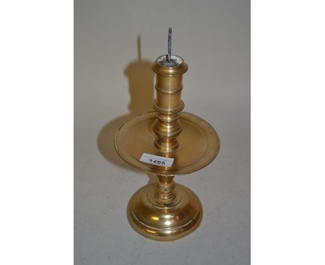 Antique brass candlestick with a wide drip pan, baluster turned column and circular base, 9.25ins high 