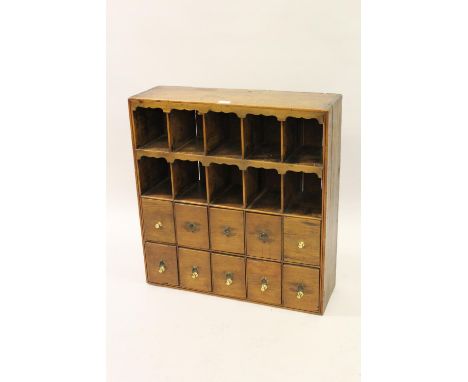 19th Century pine spice rack with two rows of five pigeon holes above two rows of five drawers, 27ins wide 