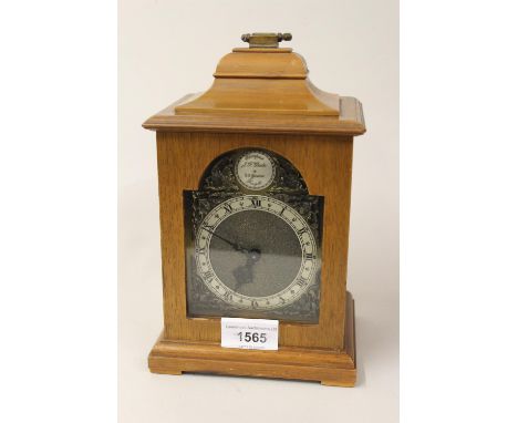 Small reproduction walnut cased mantel clock in George III style with presentation plaque to the inner rear door from the Dir