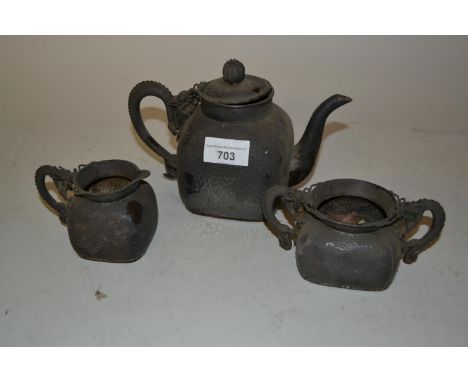 Early 20th Century Chinese silver three piece teaset with hammered bodies and dragon form handles, character marks to bases (
