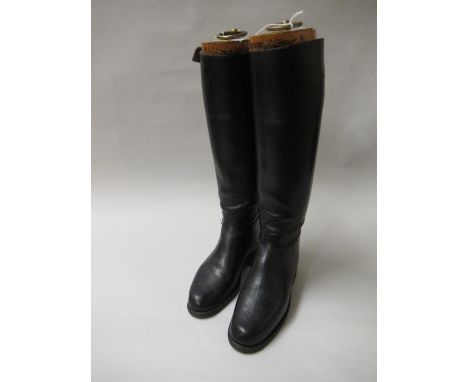 Pair of black leather riding boots with trees having gilt ring pull handle and label for Alan McAfee, Dover Street, London 