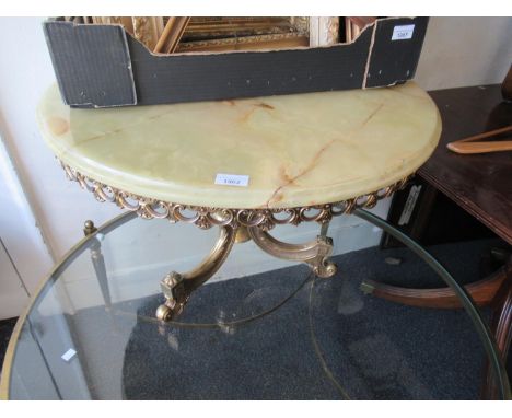 Late 20th Century circular brass and onyx top coffee table on pedestal base with C scroll legs (at fault), together with an o