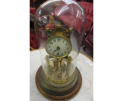 Early 20th Century brass anniversary clock (at fault) under glass dome 
