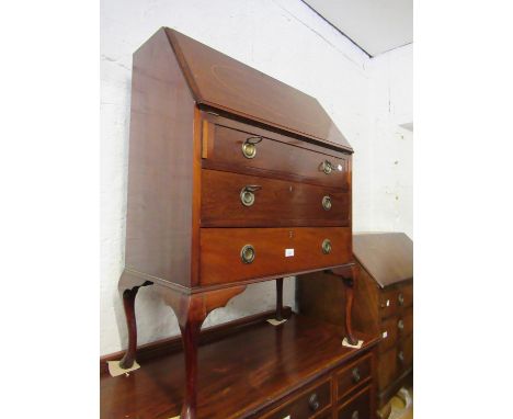 Edwardian mahogany inlaid bureau, the fall front having fitted interior above three long drawers with ring handles, on cabrio
