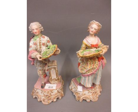 Pair of late 19th/early 20th Century French Bisque figures of a lady and gentleman carrying platters of flowers 9.5ins high 
