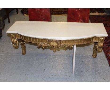 19th Century French giltwood and ghesso console / wall shelf, the marble top above a shell and floral frieze and scroll suppo