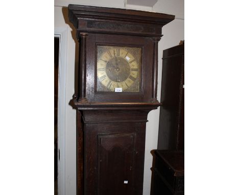 Oak longcase clock, the square hood above a rectangular panelled door, the 10in brass dial signed Richard Fowle, Uckfield, ad