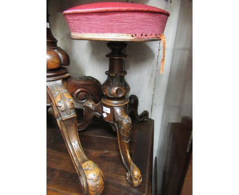 Victorian carved walnut piano stool with a swivel seat and tripod base 