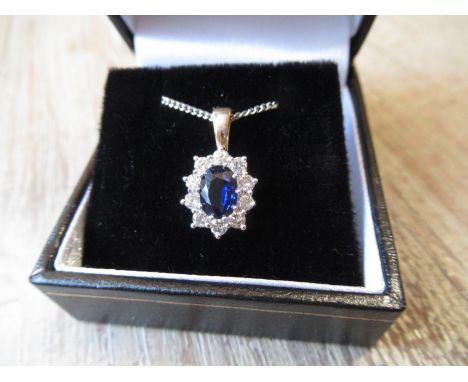 18ct Yellow and white gold oval sapphire and diamond cluster pendant on a silver chain 