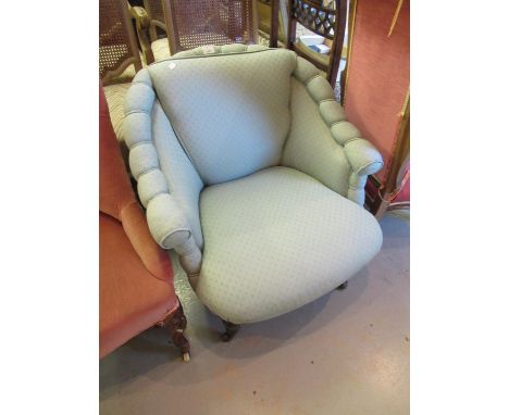 Early 20th Century drawing room armchair having pale green upholstery, raised on turned tapering front supports with brass an