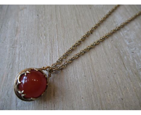 Cornelian sphere pendant on a 9ct gold chain 