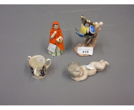 Goebel figure of a blue tit, a Staffordshire candle snuffer in the form of Red Riding Hood, a Lladro figure of a baby and a G