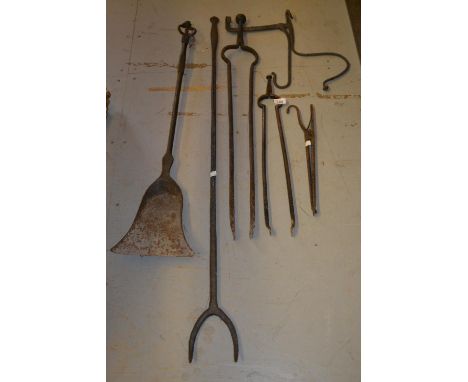Antique wrought iron log fork, similar coal shovel, two pairs of tongs and two other items 