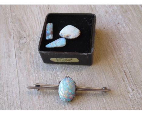 Silver opal set bar brooch together with three loose opalsThe opal in the brooch is a doublet (ie. 2 layers, a thin colourful