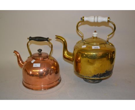 Large brass kettle with ceramic handle and a smaller copper kettle 