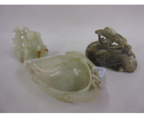 Chinese carved jade cup in the form of lotus, together with a similar carving of a stylised bird and another of figures in a 